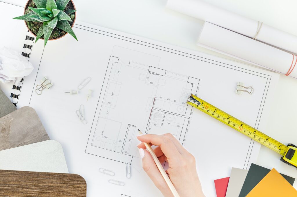 Interior designer table workplace with house plan